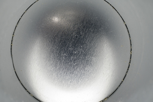 Interior of metallic can with silver circumference with horizontal shine