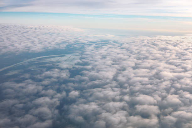 Aerial view of clouds over the Earth. Flying through the clouds in the morning