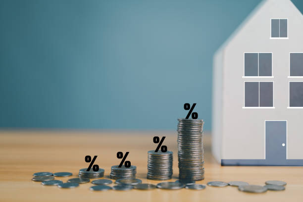 istock Stack coins as graph trend up and interest rates with house model background. FED fix recession inflation crisis by increase interest rate that effect to house buyer. Mortgage loan, financial. 2148900532