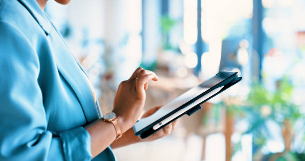 Hands, tablet and typing in office at startup with web, contact and research on web for creative career. Employee, person and digital touchscreen for communication, scroll and click at media agency