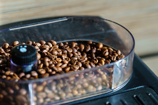 Singleorigin coffee beans in a transparent container with a black lid