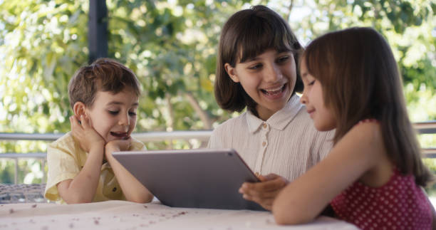 istock Happy Children Using Digital Tablet Outdoors 2148902787