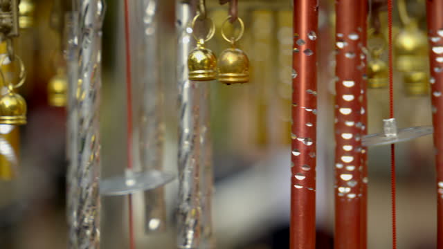Close-up wind Chimes hangs on the porch of the house. Group of wind Chimes hanging on a festival