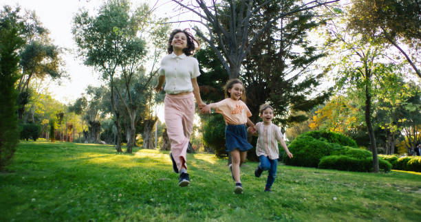 istock Happy children running outdoors in a public park in springtime 2148903594