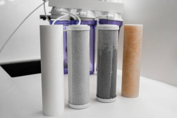 istock Four filters for the purification system of water on the table in the kitchen. 2148903968