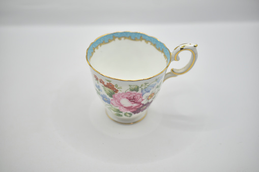 Studio table top shot of an antique tea cup and saucer with shallow depth-of-field.