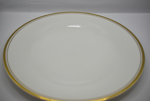 white porcelain plate with gold rim