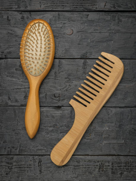 istock Two wooden combs on a wooden background. 2148909551