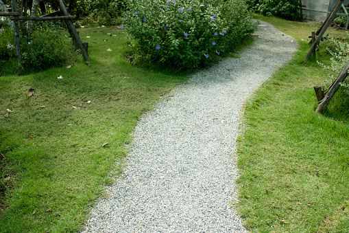 Garden Stepping Stone Path through Green Grass Lawn - stock photo