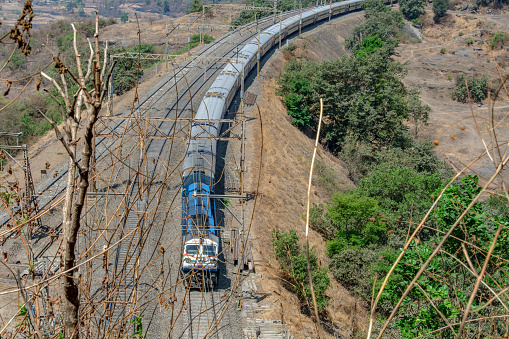 Pune, India - April 14 2024: WDP4D diesel locomotive hauls a passenger train near Pune India.