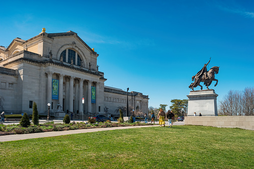 People walk in front of the Saint Louis Art Museum in Forest Park in St Louis, Missouri, USA on a sunny day.