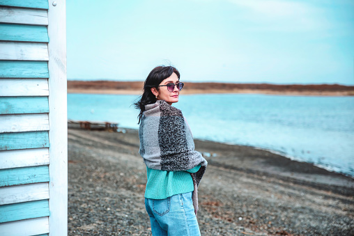 49 year old Russian woman in blue sweater on an early spring  day against japanese sea