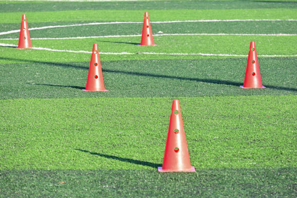 istock artificial green grass soccer field with orange training cones 2148914102