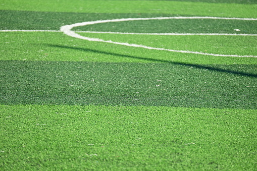 Artificial soccer green turf with yellow and white lines