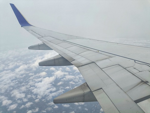 A photo of an airplane wing taken from inside the airplane