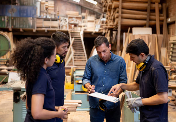 istock Manager talking to his employees at a timber factory 2148914809