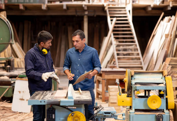 istock Employee working at a wood factory and asking his manager a question 2148914859