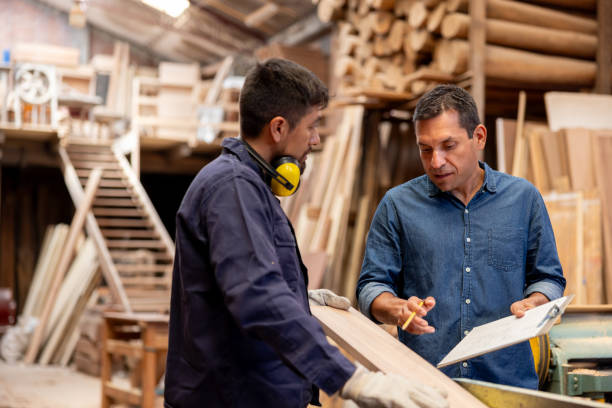 istock Manager giving instructions to a worker at a timber factory 2148914865
