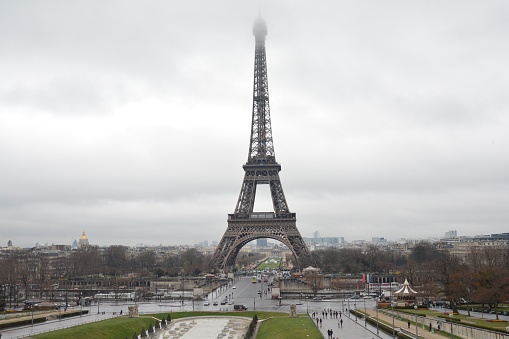 Landscape of the Eiffel Tower and Champs-de-Mars, enveloped by clouds on a rainy day in Paris, France