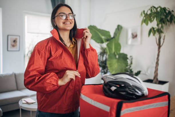 Female Delivery Person Preparing for Assignments