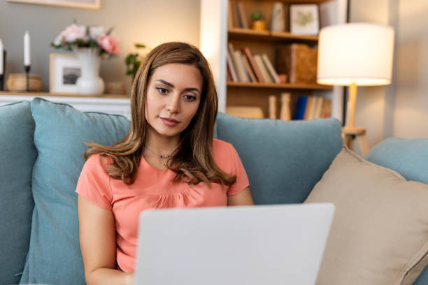 istock Beautiful woman freelancer noting information for planning project doing remote job via laptop computer. woman laughing while reading email on modern laptop device . 2148920110