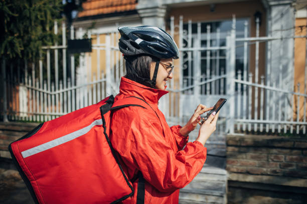 istock Delivery woman checking smart phone 2148920343