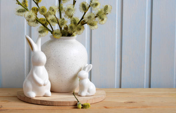 istock Easter, spring still life with blooming willows and Easter bunny figurines on the table in the cottage. Festive arrangement. 2148920822
