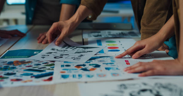 istock Close-up of team hands analyzing Environmental Social Governance (ESG) reports, reinforcing responsible business strategies in an office setting. ESG sustainable business office night. 2148920905