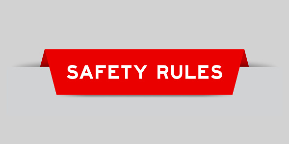 Red color inserted label with word safety rules on gray background