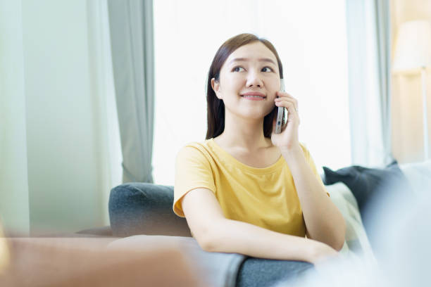 istock Woman working and sending a message on smartphone while living at home. 2148923167
