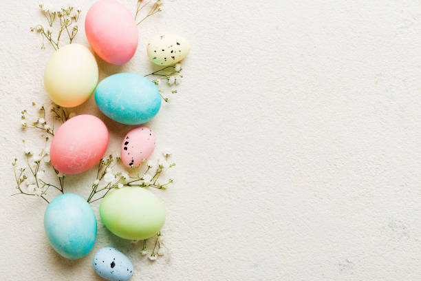 istock Happy Easter composition. Easter eggs on colored table with gypsophila. Natural dyed colorful eggs background top view with copy space 2148925944
