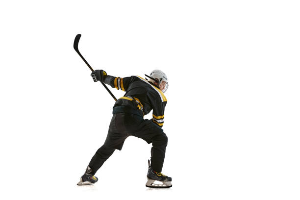 Determined man, hockey player preparing for competition in motion, training isolated on white background. Concept of professional sport, competition, game, tournament, active lifestyle