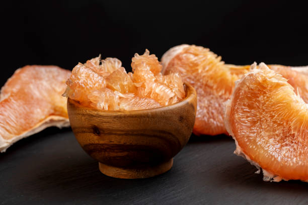 istock peeled red and pink pomelo on the table 2148926895