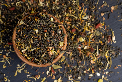 green tea with berries and flowers, delicious dry tea with additives for taste and aroma
