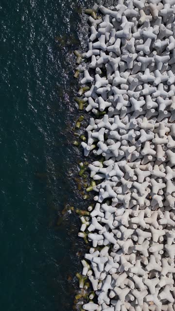 Aerial drone view of a breakwater. breakwater in the sea, a collection of concrete tetrapod breakers
