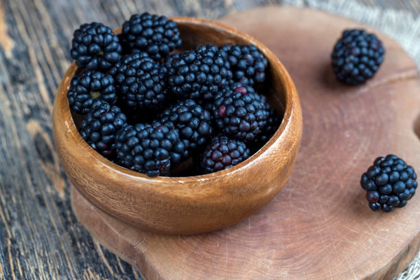 ripe blackberries in drops of water during cooling, condensation drops on blackberries in a bowl
