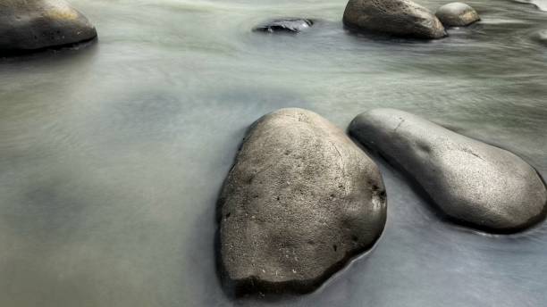 istock River in long exposure shot with Surrounding Forest and Rocks 2148927988