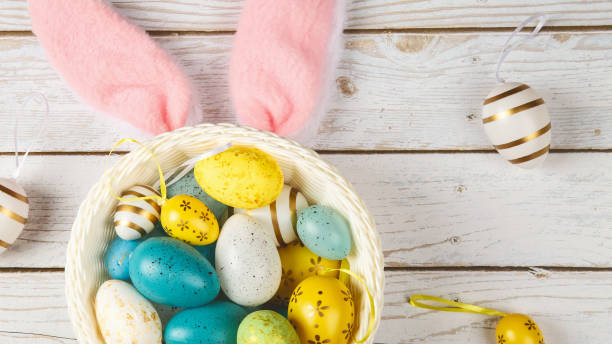 istock Happy Easter concept. Preparation for holiday. Easter eggs on the basket isolated on wooden background. Simple minimalist flat lay top view copy space 2148929162