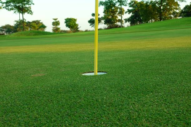 istock Hole with flagpole in golf course on green grass field. 2148931920