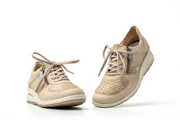 istock Beige female sneakers on white 2148932041