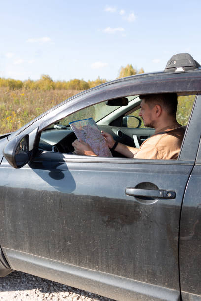 istock A man in a car is studying a road map 2148933172