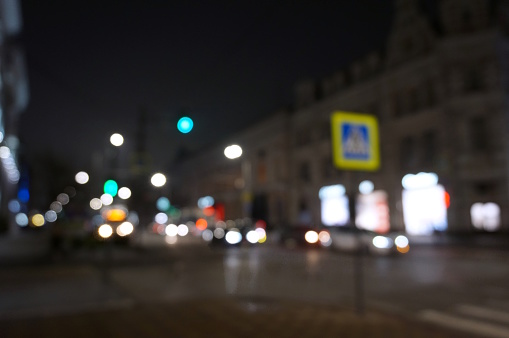 Blurred background. A street with cars at night.