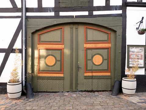 Wooden double doors of half-timbered historic house painted in various colors in old town of Bogense, Funen, Denmark