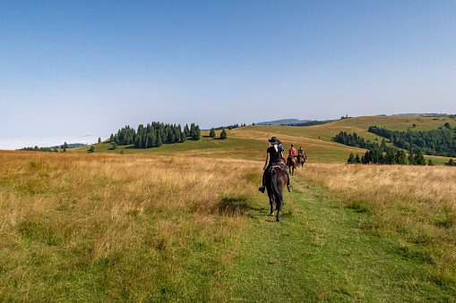 Nicklasmarkt, Gheorgheni, Romania - July 26, 2023: Horseback riding in the carpathian landscape