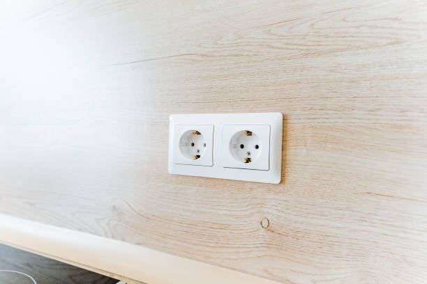istock Two white wall sockets installed on a hardwood wall 2148936431