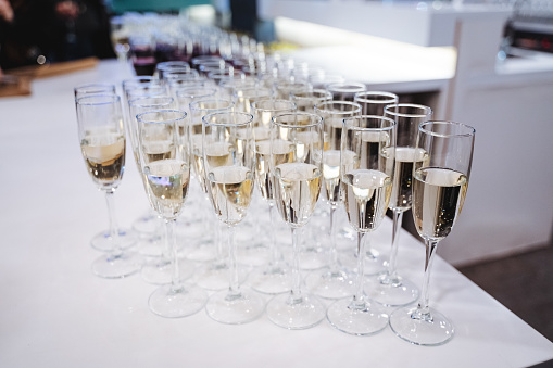 A set of champagne stemware placed neatly on a white table, creating a visually appealing display of glassware