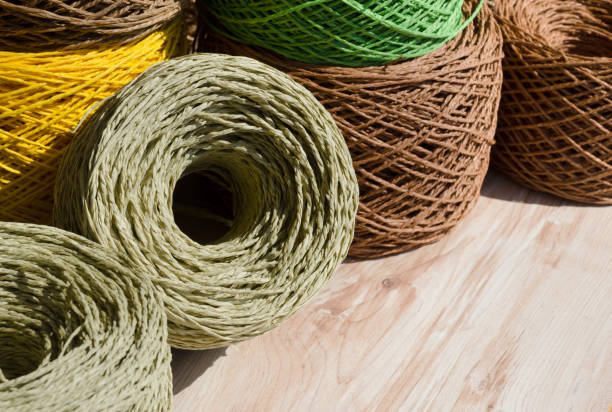 Raffia balls close-up. Skeins of multi-colored raffia are ready for knitting. Eco material for handmade work.