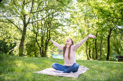 Young Woman doing yoga outdoors in the park