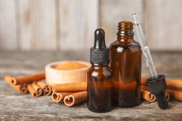 istock Cinnamon aromatic essential oil and cinnamon sticks on a wooden background. Aromatherapy. Organic cosmetic oil. Spa concept. Place for text. Copy space. 2148937241