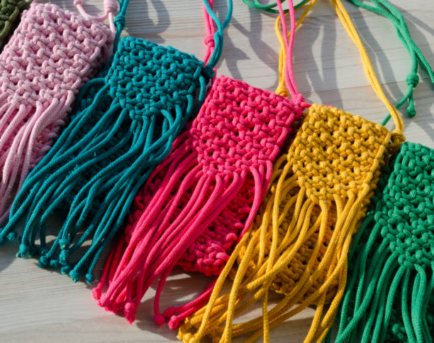 istock A little bag. Knitting macrame, pattern of multi-colored cotton cords. Handmade concept, hobby. 2148937563
